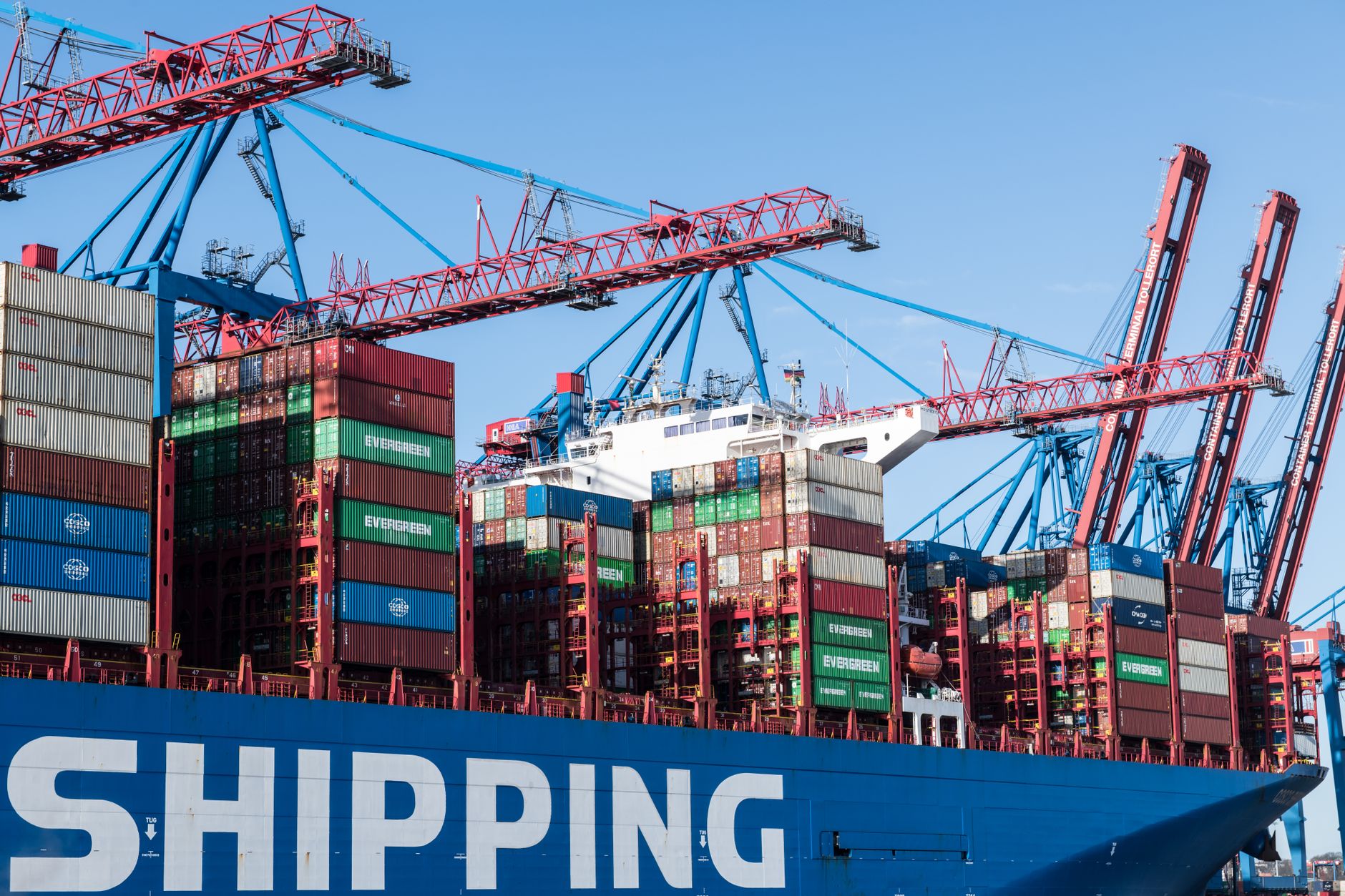 Shipping containers and cranes at Hamburg port showcasing global trade.
